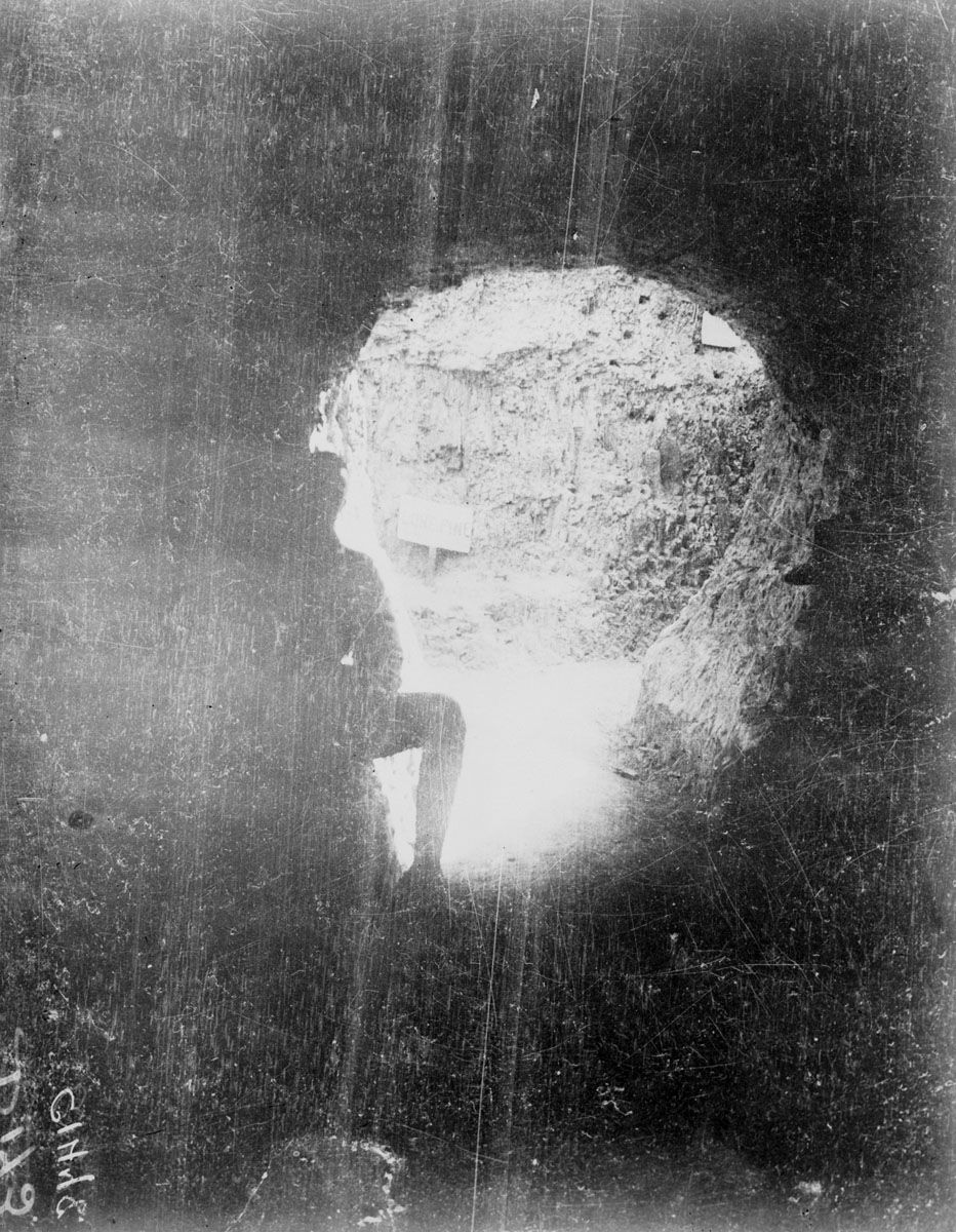 The silhouette of a soldier by the opening of a 200-yard long tunnel leading to Lone Pine, 1915.
